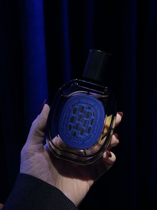 Alyssa Brascia holding Diptyque Orphéon perfume