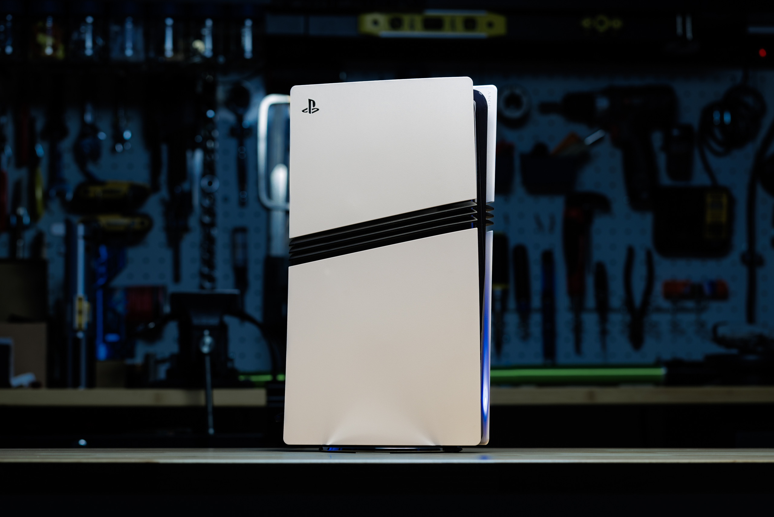 The PS5 Pro, a new PlayStation in white, with black strakes along its sides.
