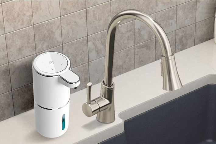 Soap dispenser next to faucet.