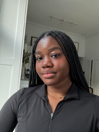 Associate Beauty Editor Maya Thomas wearing the Charlotte Tilbury Pillow Talk Beauty Blush Wand in Pillow Talk