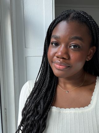 Associate Beauty Editor Maya Thomas wearing the Charlotte Tilbury Pillow Talk Beauty Blush Wand in Pillow Talk