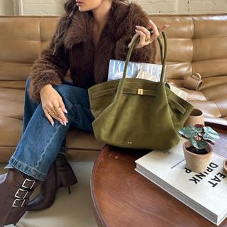 Woman wears JW Pei Hana tote in olive green.
