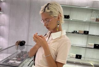 Iris Law wearing a powder pink polo top.