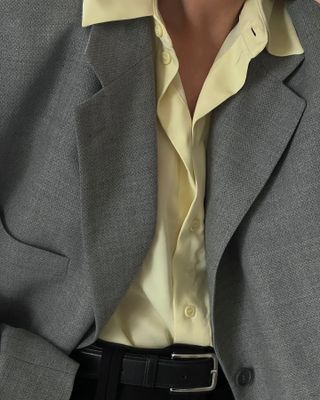 Influencer wears a yellow top.