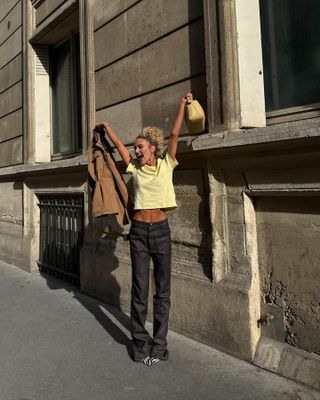 Influencer wears a yellow top.