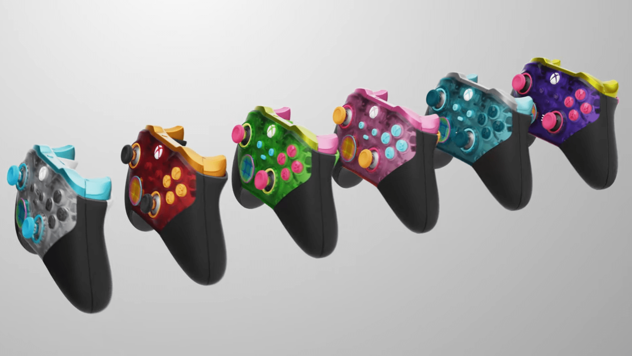 All of the new translucent controller options arrayed in a row, from left to right: white, red, green, pink, blue, and purple.