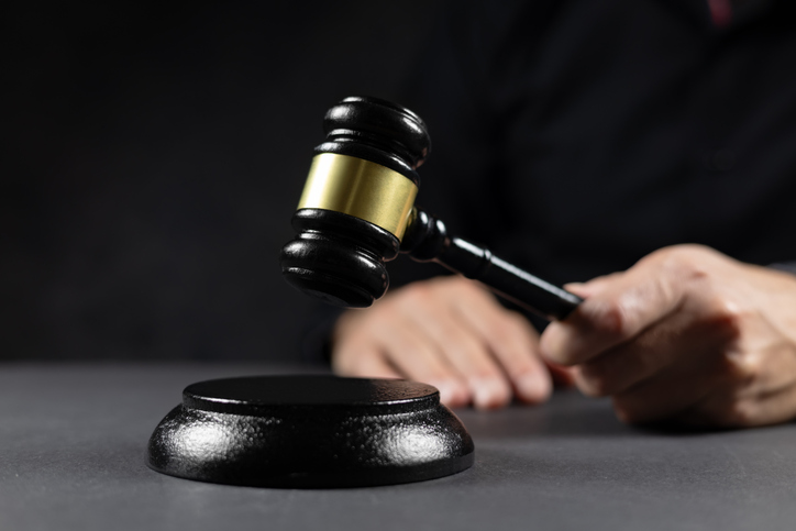 judge's gavel in hand judges is placed on a table in the legal counsel's office