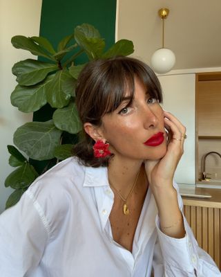 @juliesfi with chocolate brown hair and a wispy fringe