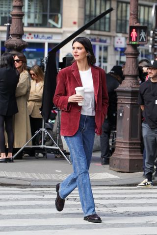 Kendall Jenner wears a red blazer, white t-shirt, jeans and burgundy lug-sole loafers.