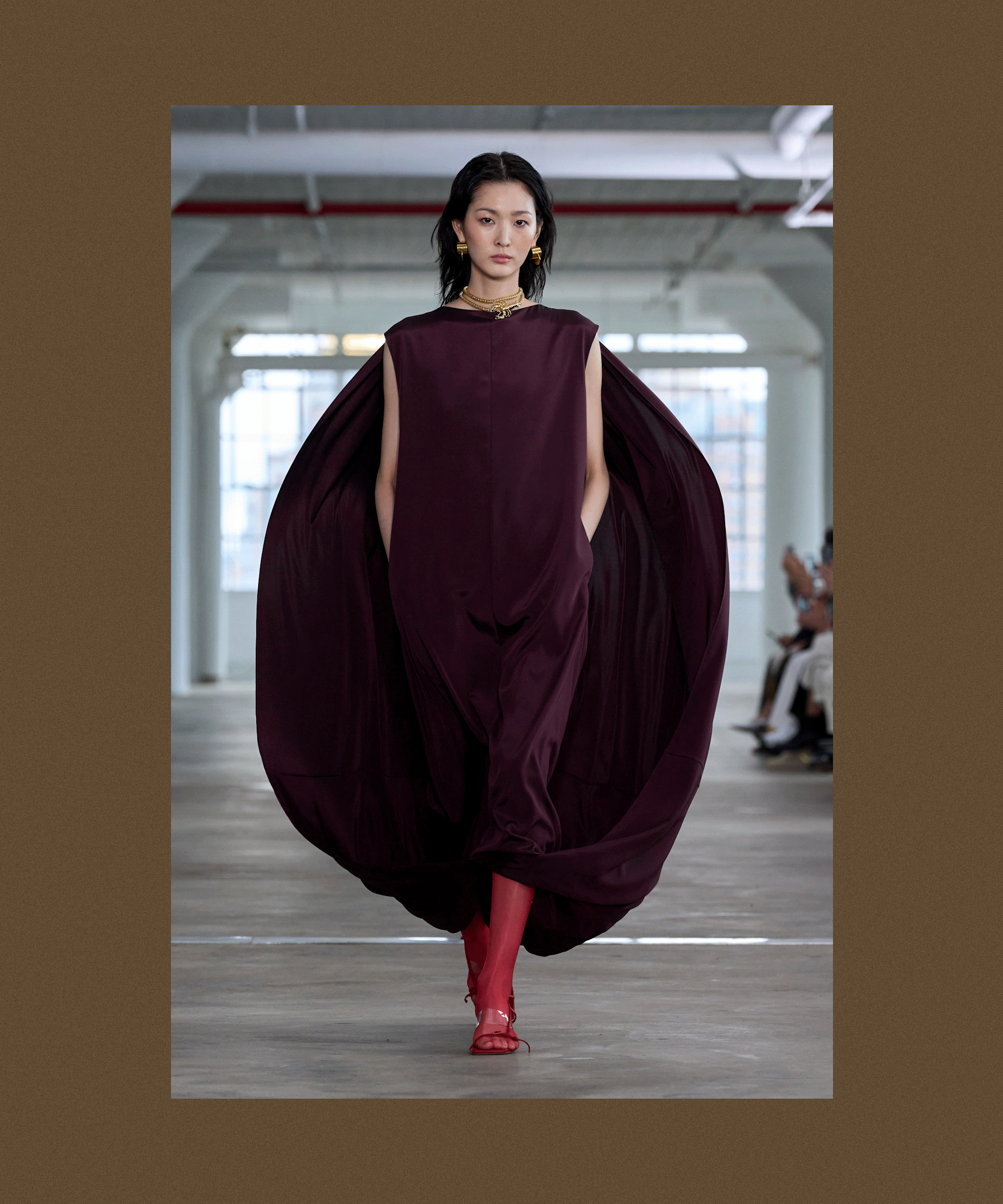 A brown backdrop with flashing images from the S/S 25 Tibi show, showcasing tights being styled with dresses and sets for spring.