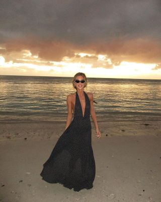 Emili Sindlev wearing a halter dress on the beach.