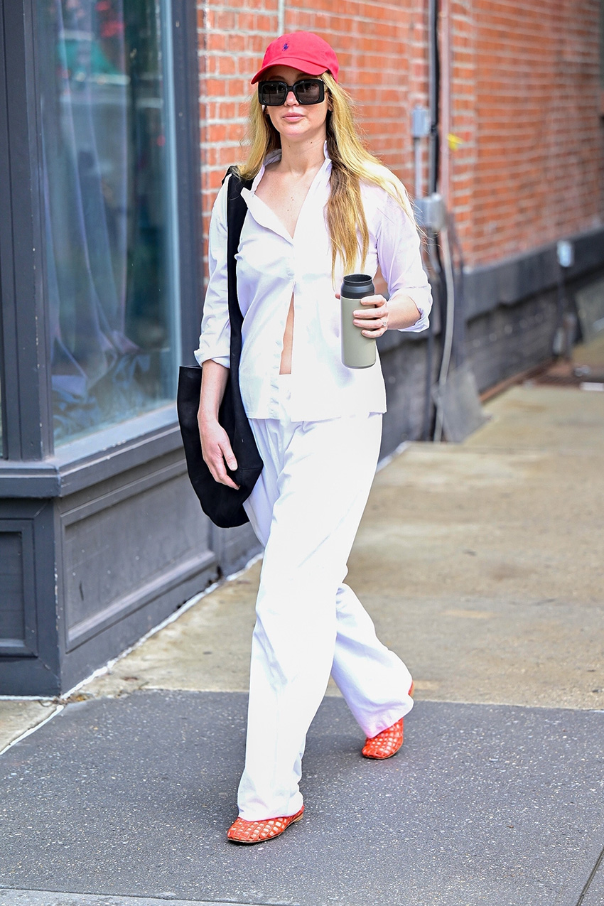 Jennifer Lawrence wearing a white outfit and The Row jellies