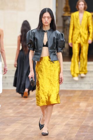 a runway model wears yellow