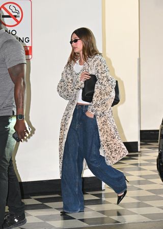 Hailey Bieber at Sushi Park in West Hollywood with Stassi, Kendall, and Kylie Jenner wearing low loose jeans with a fur coat and black clutch.