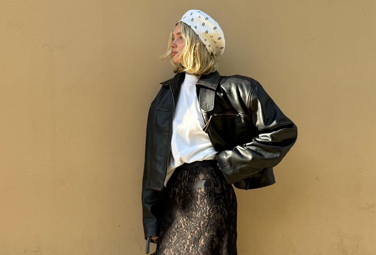 Elsa Hosk wearing a white hat and T-shirt with a leather bomber jacket and lace skirt.