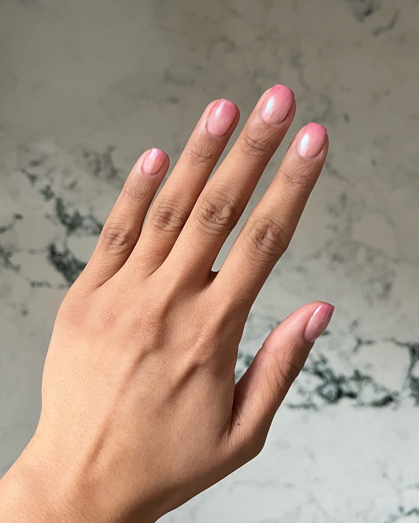 Iram Shelton wearing shimmery pink nail polish