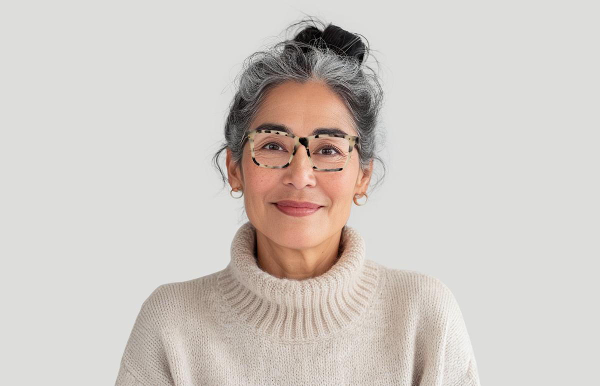 model wears glasses and white turtleneck sweater
