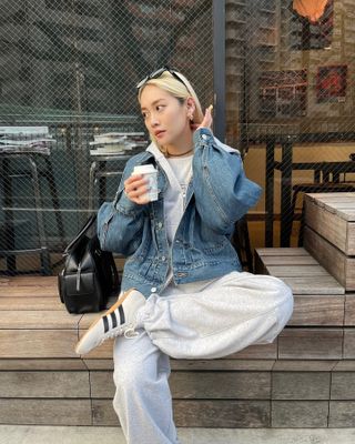 Woman in denim jacket and Adidas Tokyo sneakers