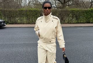 Woman in cream funnel neck jacket and pants