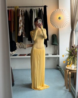 Laura Reilly wearing a yellow drop waist dress.