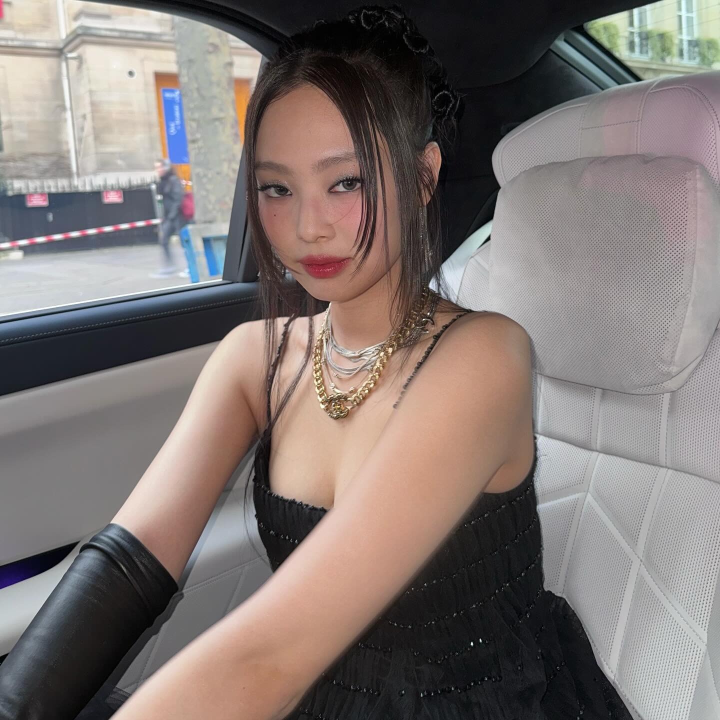 Jennie Kim taking a car selfie wearing soft pink makeup