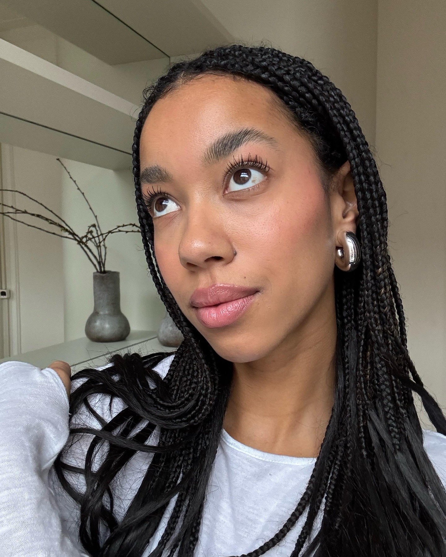 Creator @amaka.hamelijnck taking a selfie wearing soft pink makeup