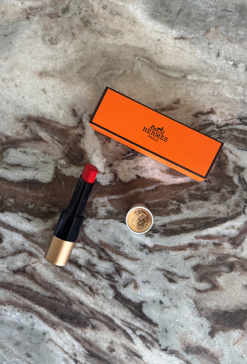 Hermes Rouge Hermes Silky Lipstick Shine in Rouge Amazone with orange Hermes box on marble table