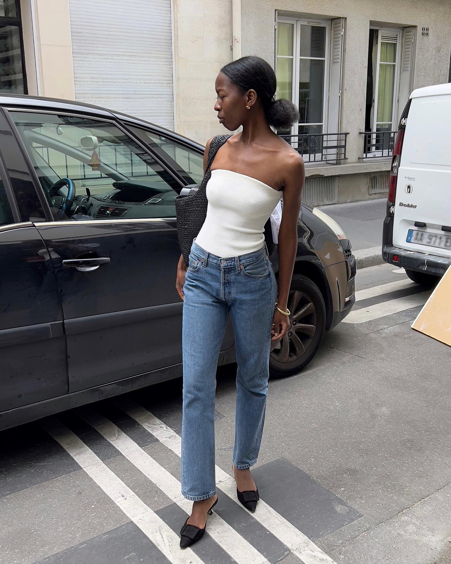 Influencer wears a white strapless top.