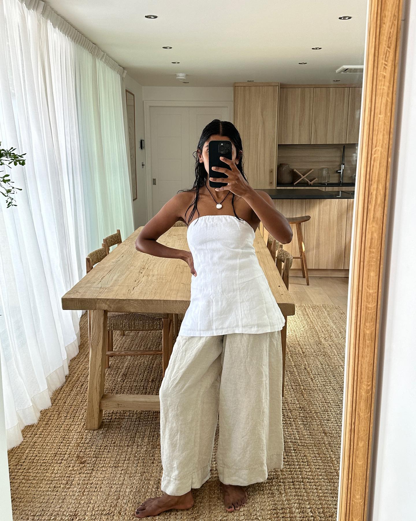 Influencer wears a white strapless top.