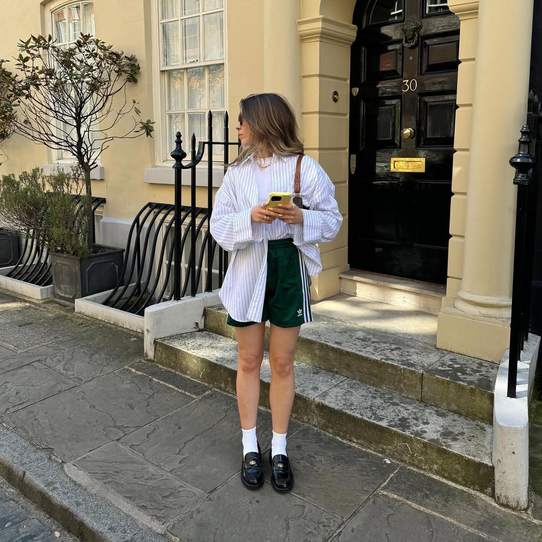 An influencer wearing adidas shorts.