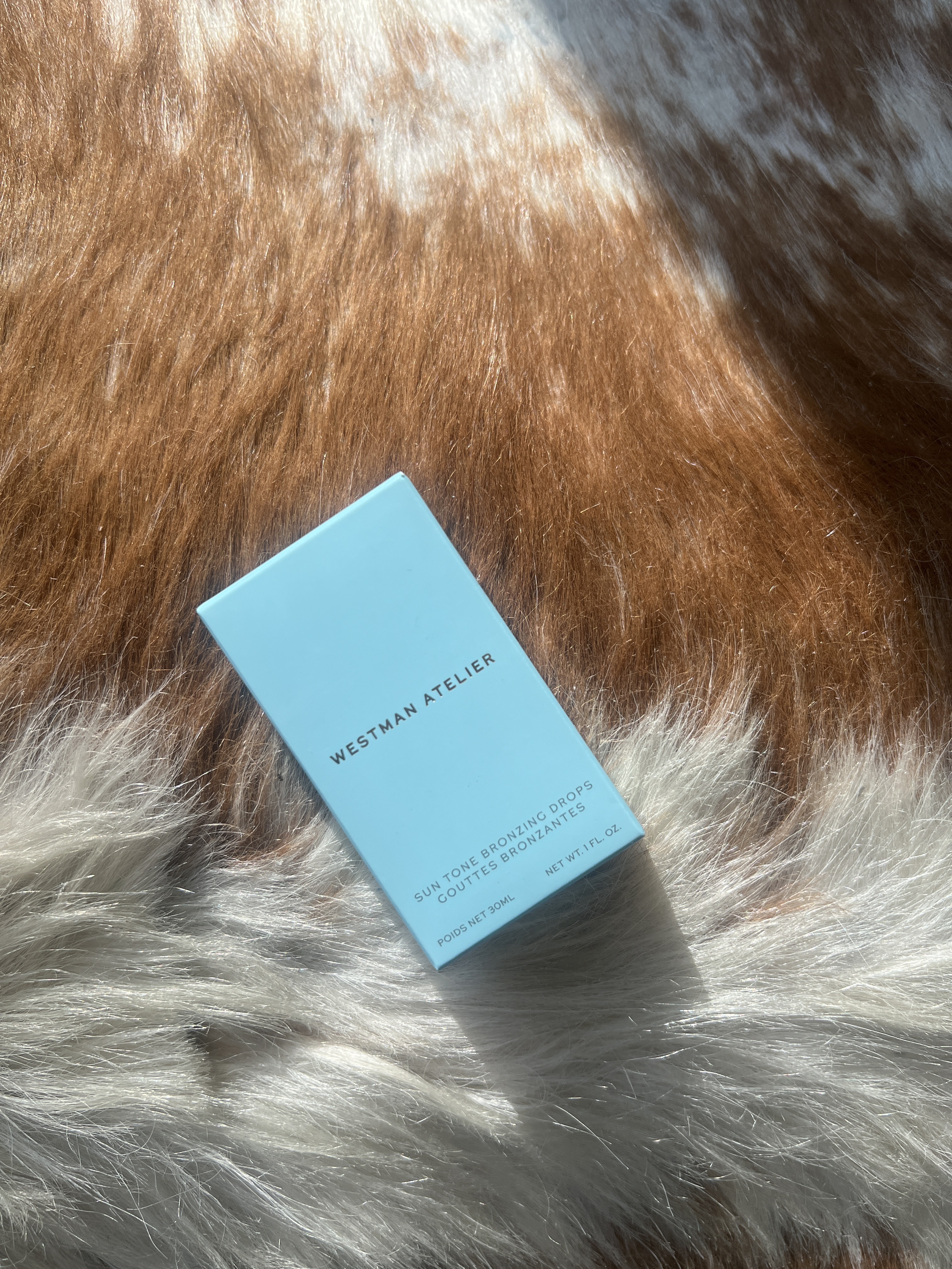 An image of Who What Wear SEO Writer Ava Gilchrist reviewing the Westman Atelier Sun Tone Bronzing Drops.