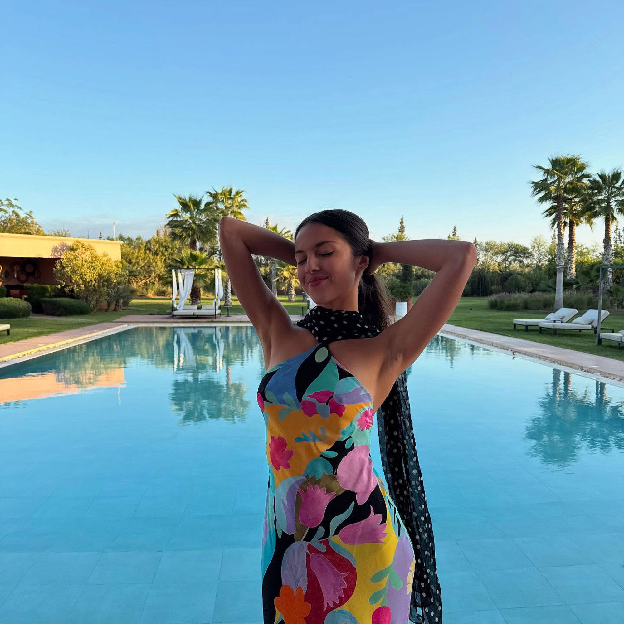 Olivia Rodrigo wears a floral and polka dot dress by Rixo