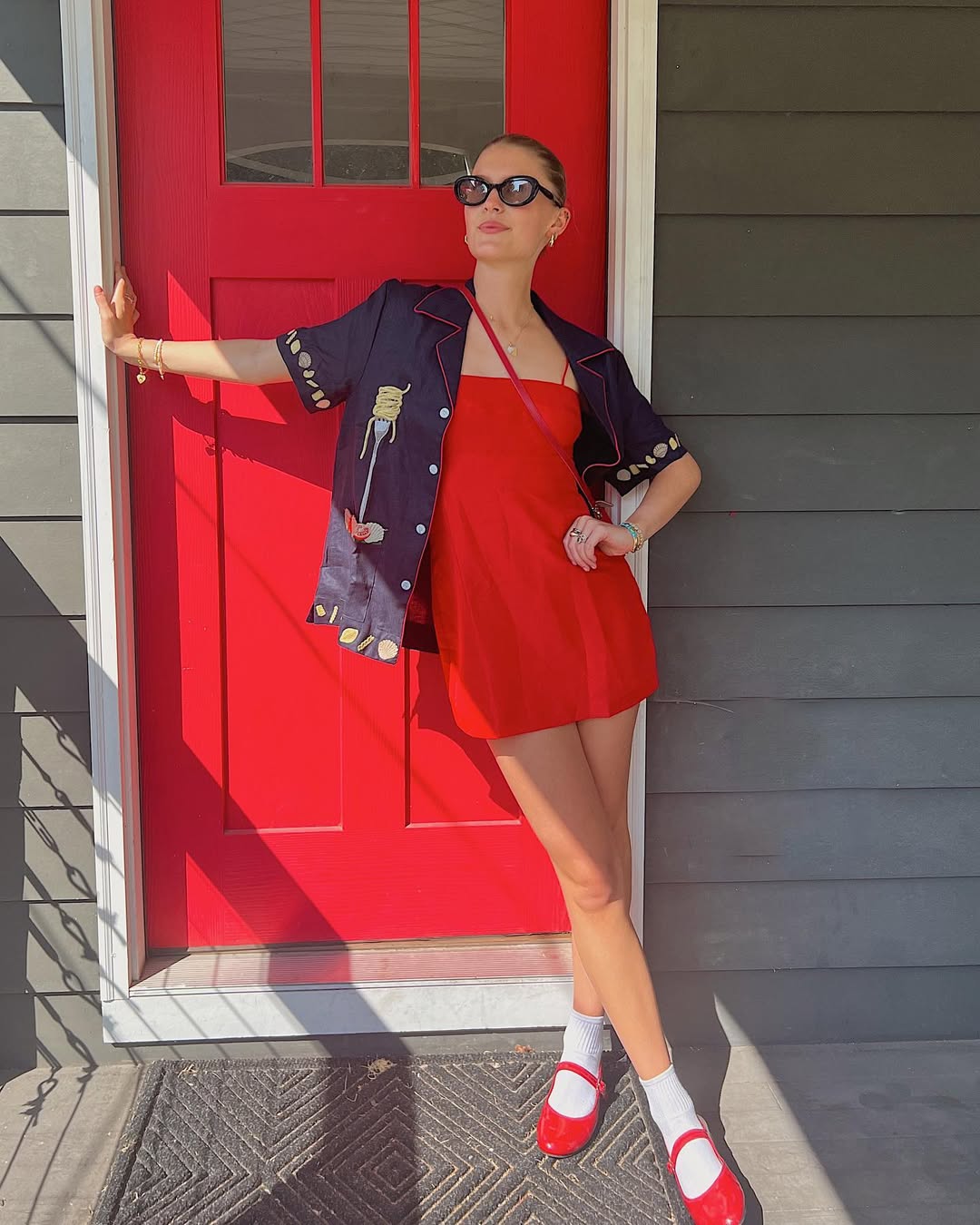 Woman wearing red minidress with ballet flats in a summer 2025 outfit.