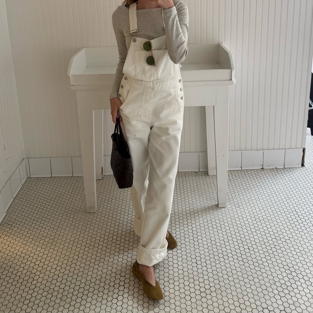 A woman wearing overalls.