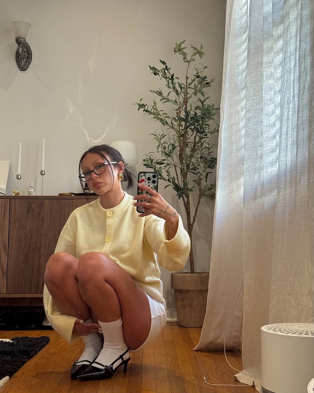 A woman wearing a butter yellow cardgian.