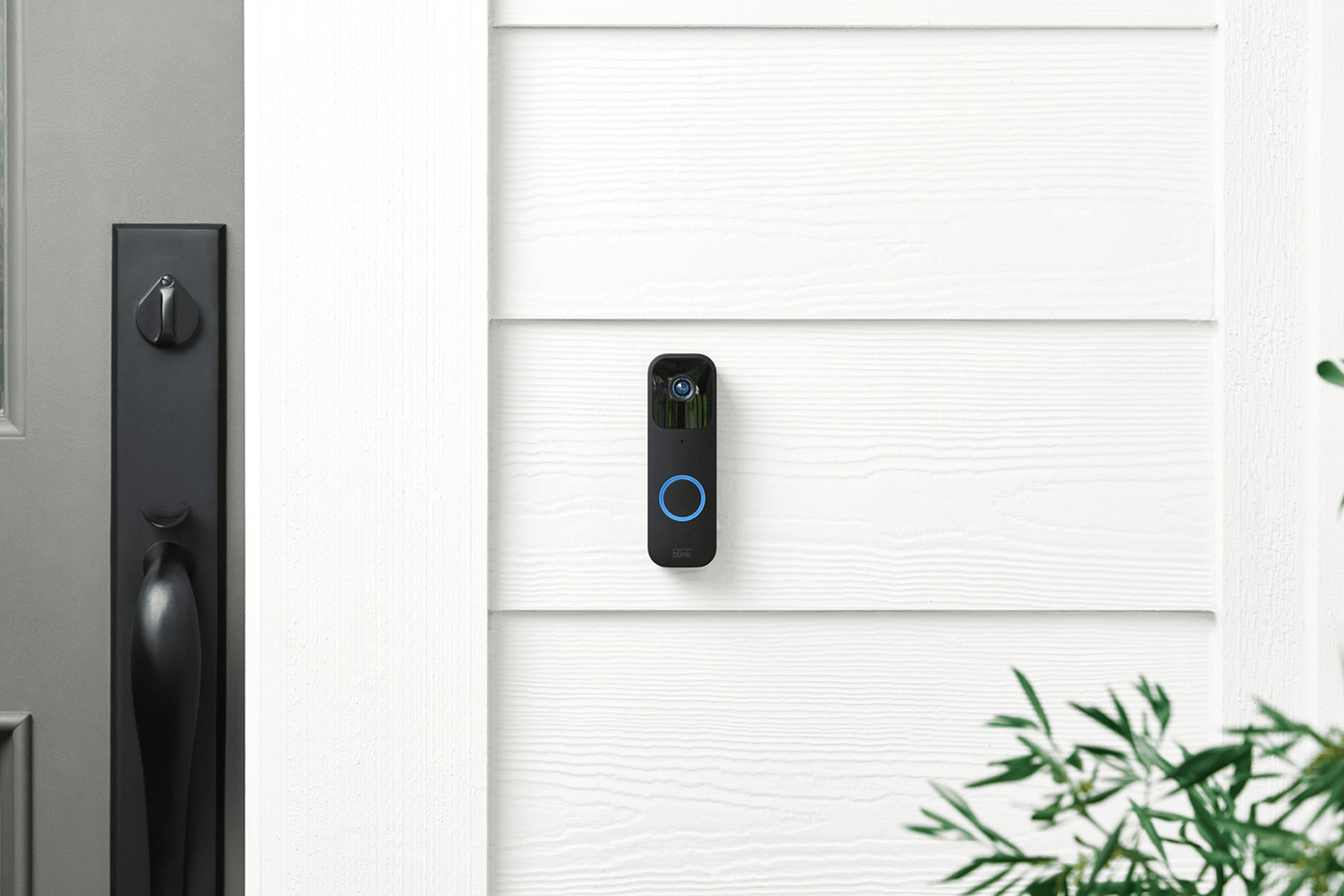 Blink video doorbell mounted on house