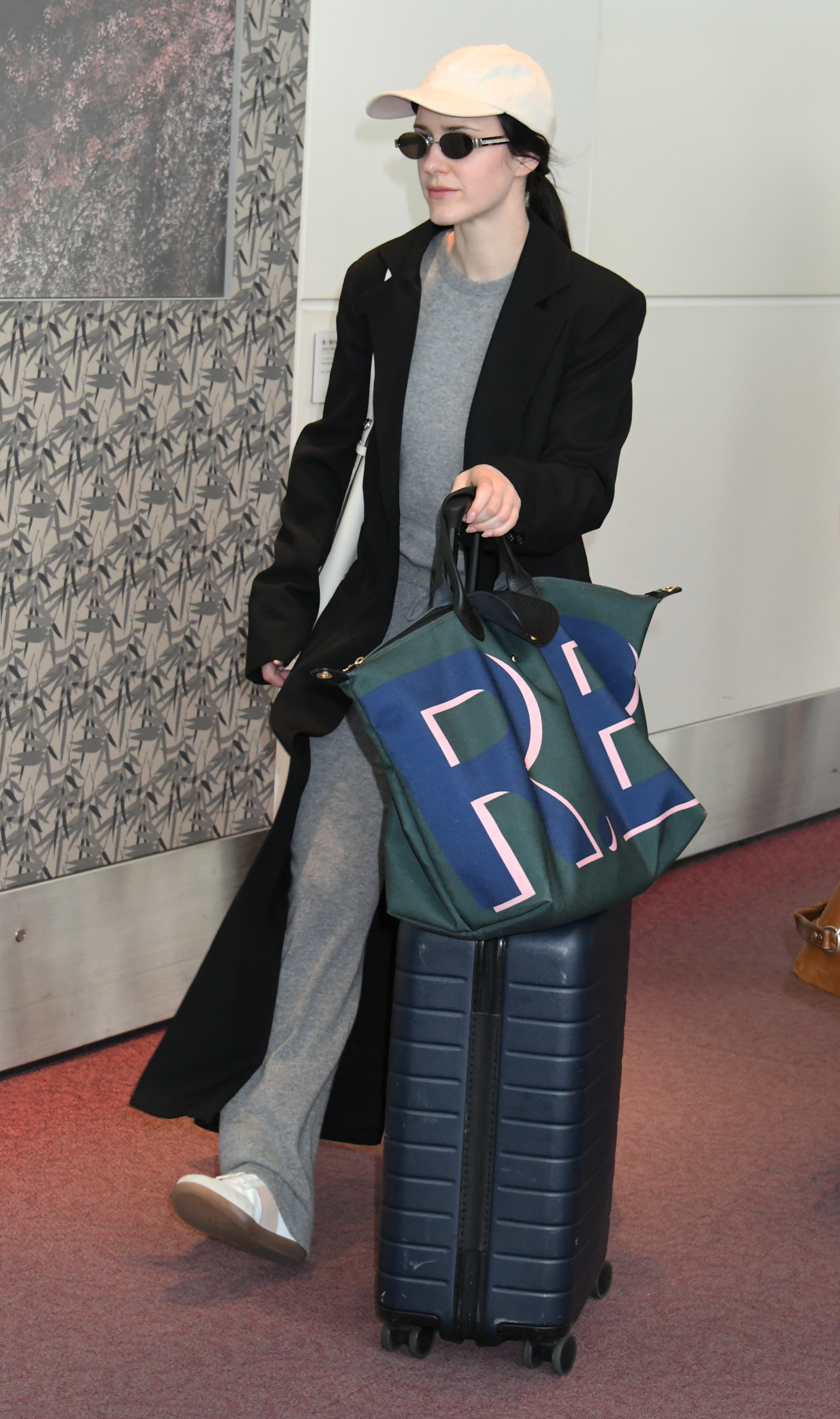 Rachel Brosnahan carrys a Longchamp bag.