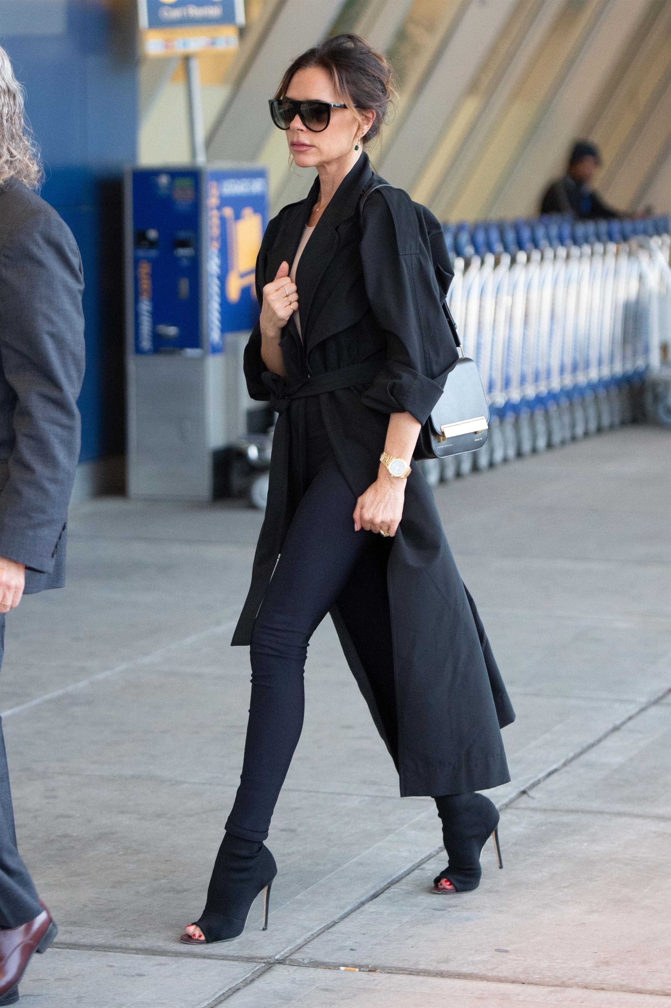 Victoria Beckham wears peep-toe shoes at the airport.