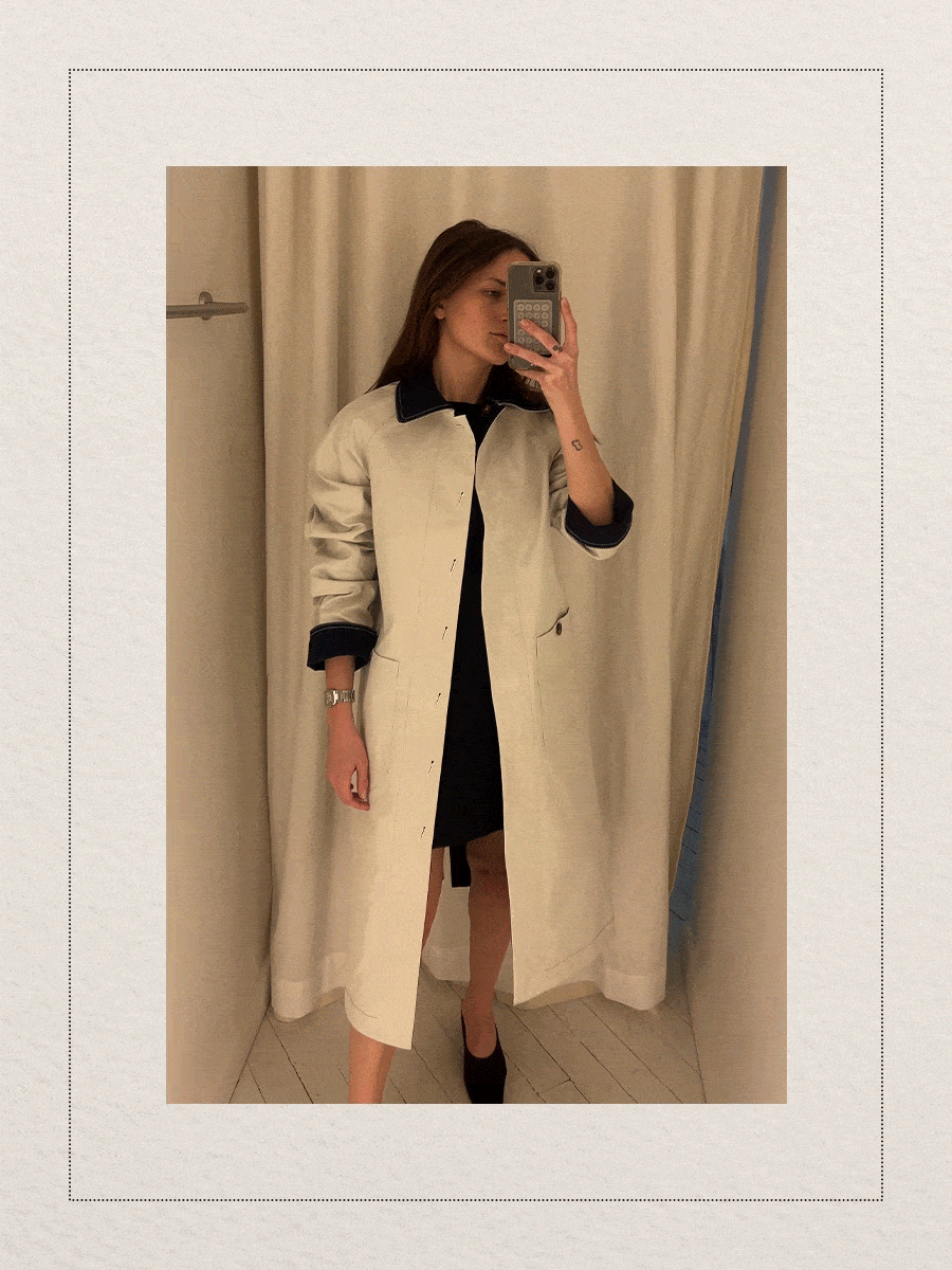 Eliza Huber at the new Aligne pop-up store in New York City's SoHo district trying on a reversible stone and navy trench coat.