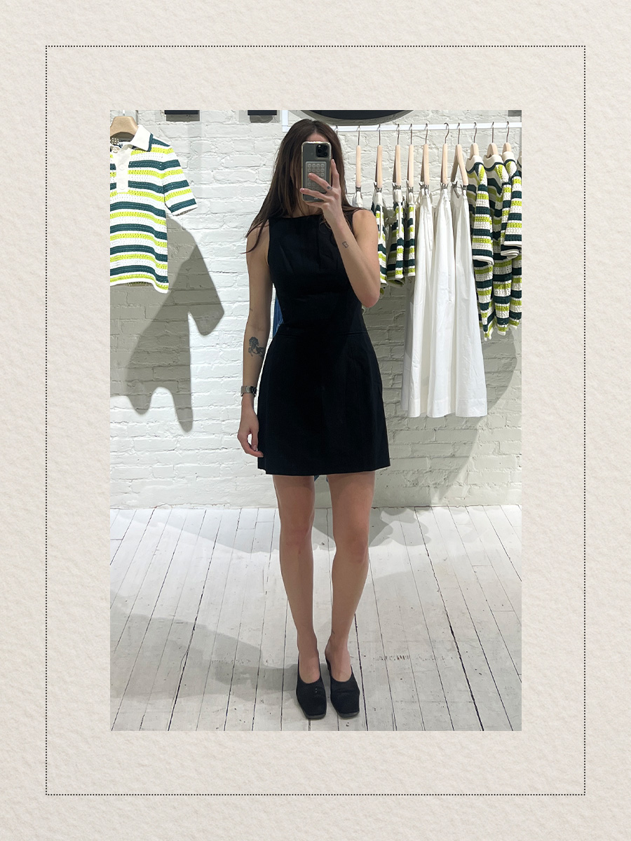 Eliza Huber at the new Aligne pop-up store in New York City's SoHo district trying on a black sculpted linen minidress.