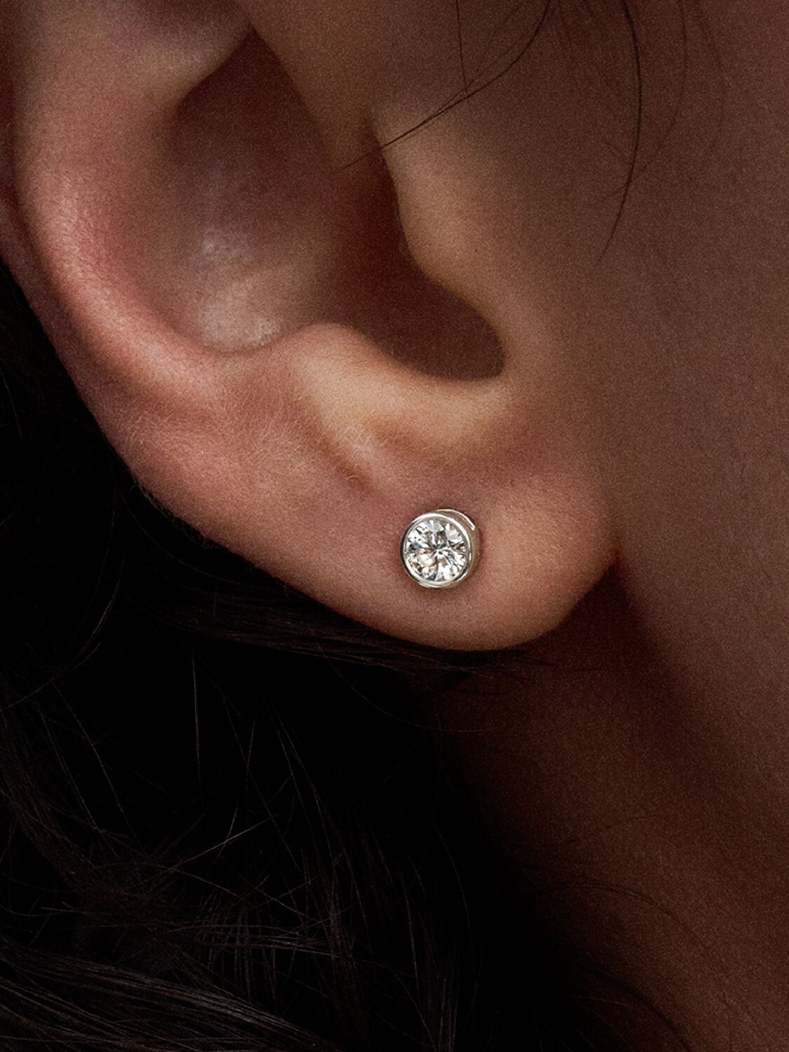 model wears pandora gold lab grown diamond stud