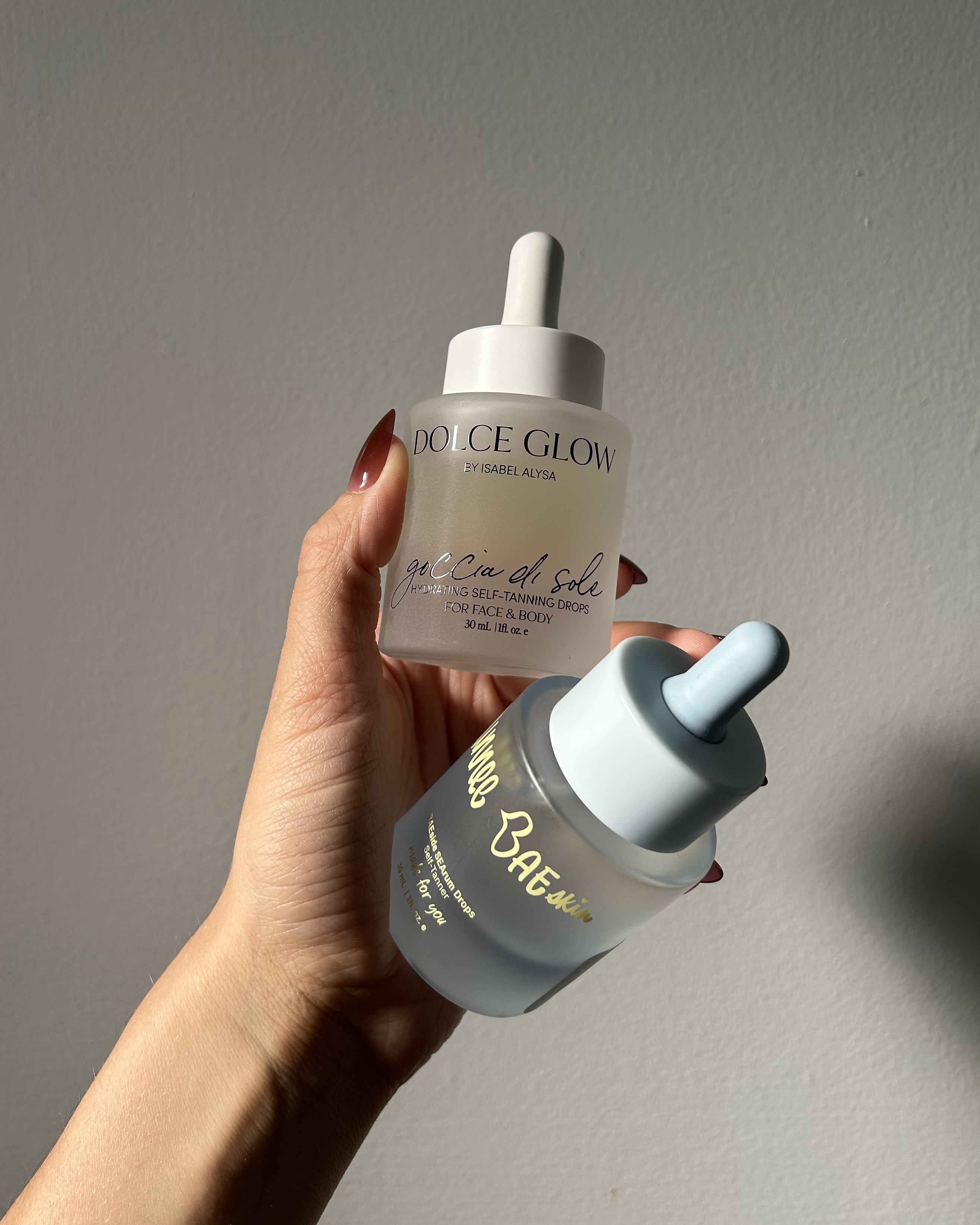 Alyssa Brascia holding self-tanning serums.