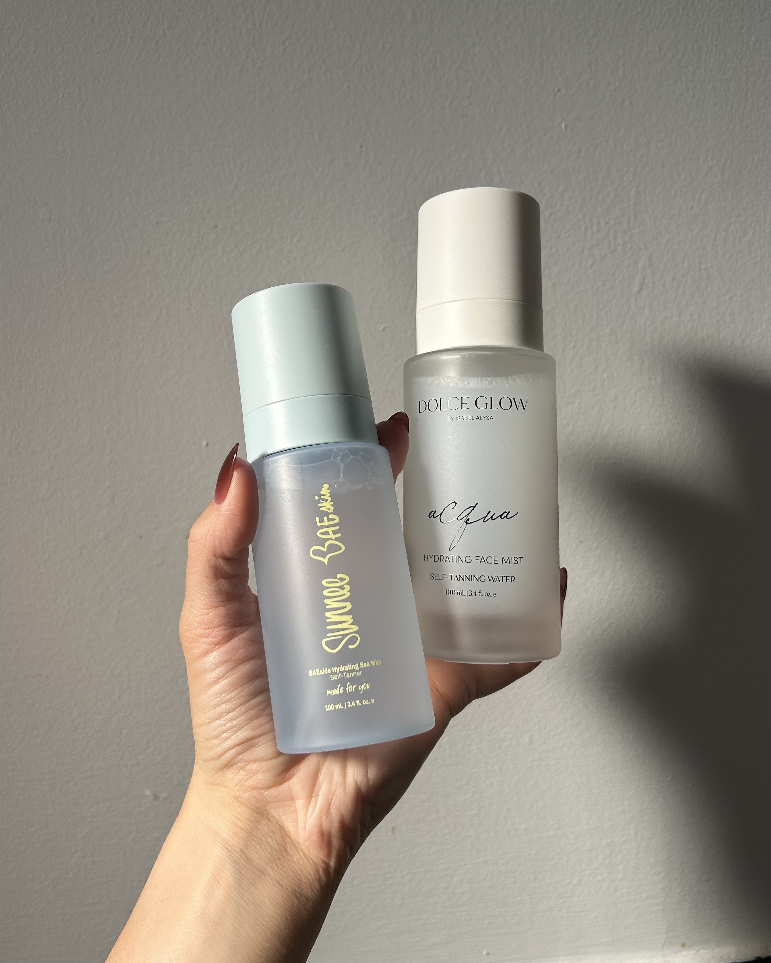 Alyssa Brascia holding facial tanning mists.