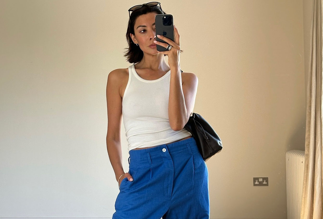 Woman in white tank top and blue pants