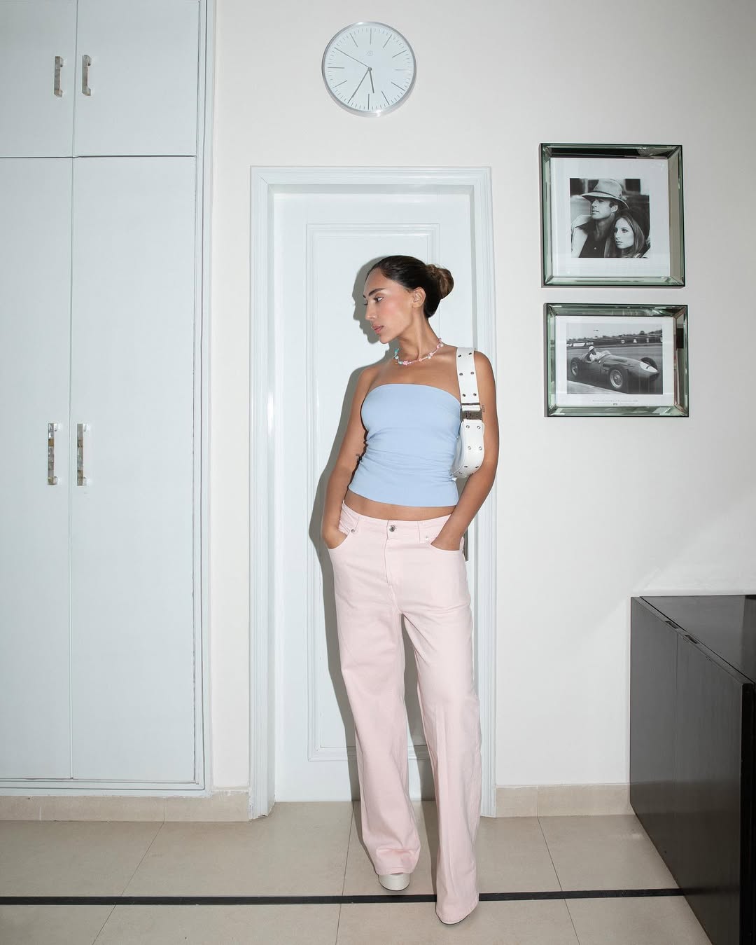 woman wearing strapless top and light pink jeans summer outfit 2025