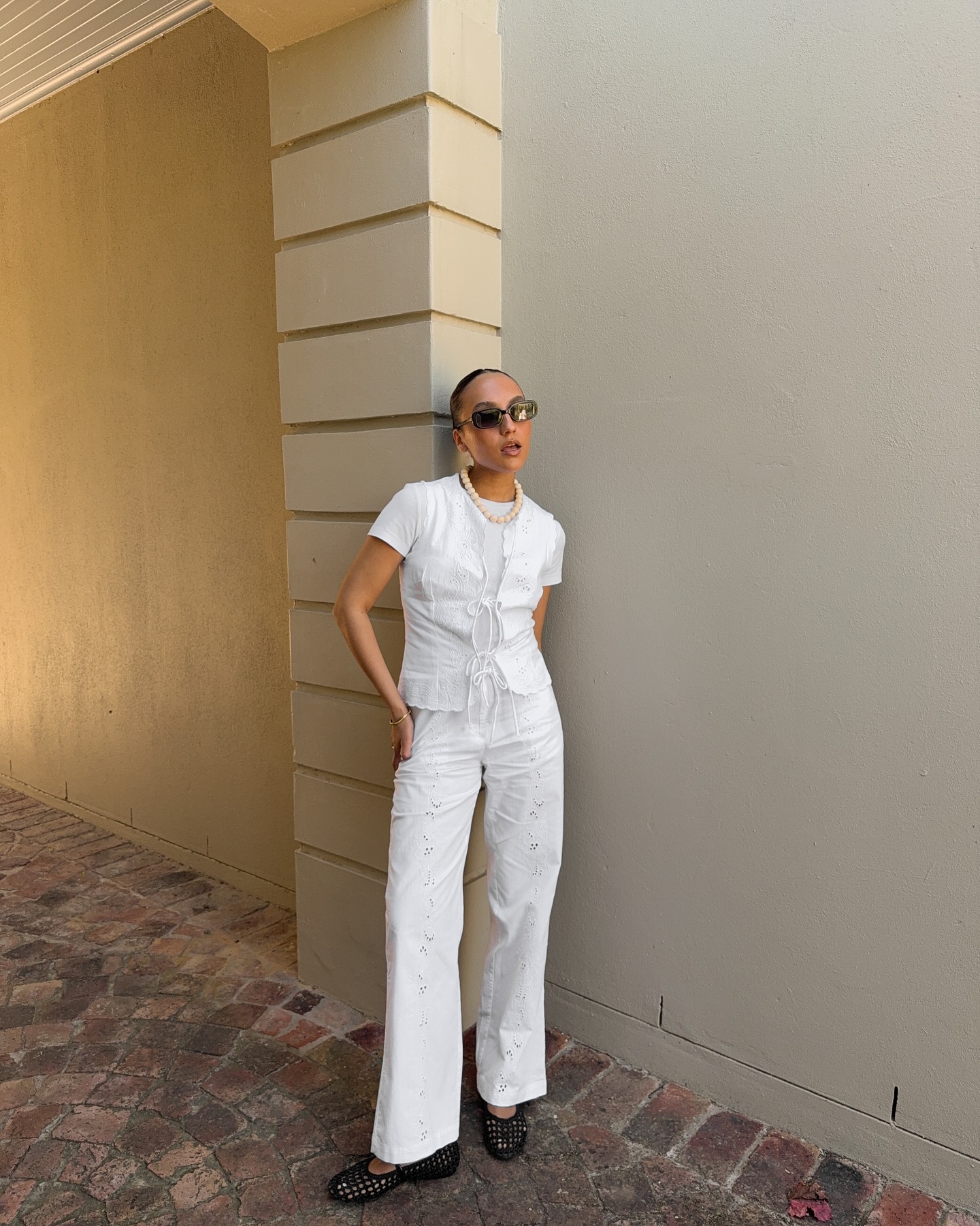 Influencer wears lattice ballet flats.