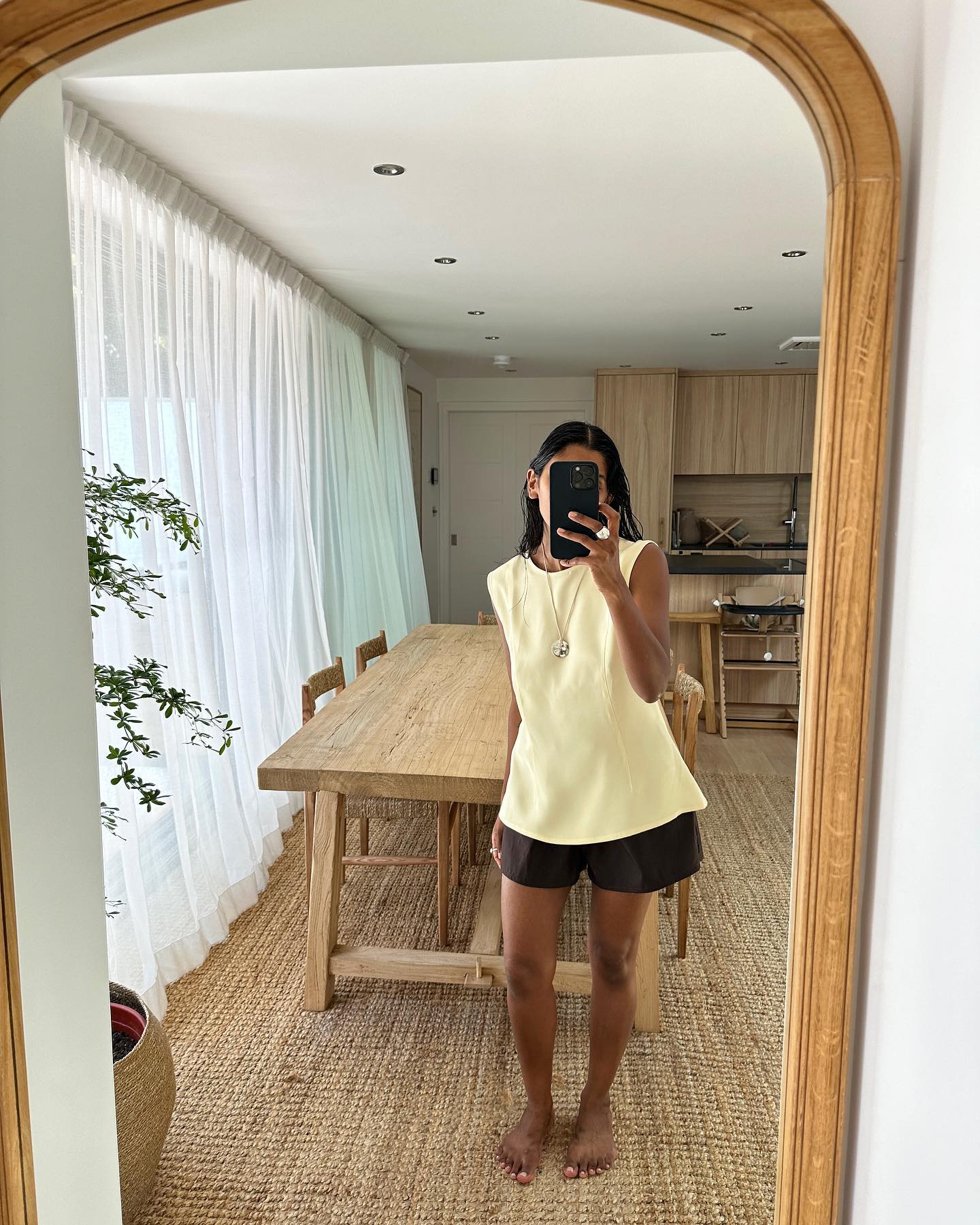 An image of @monikh wearing a waisted top.