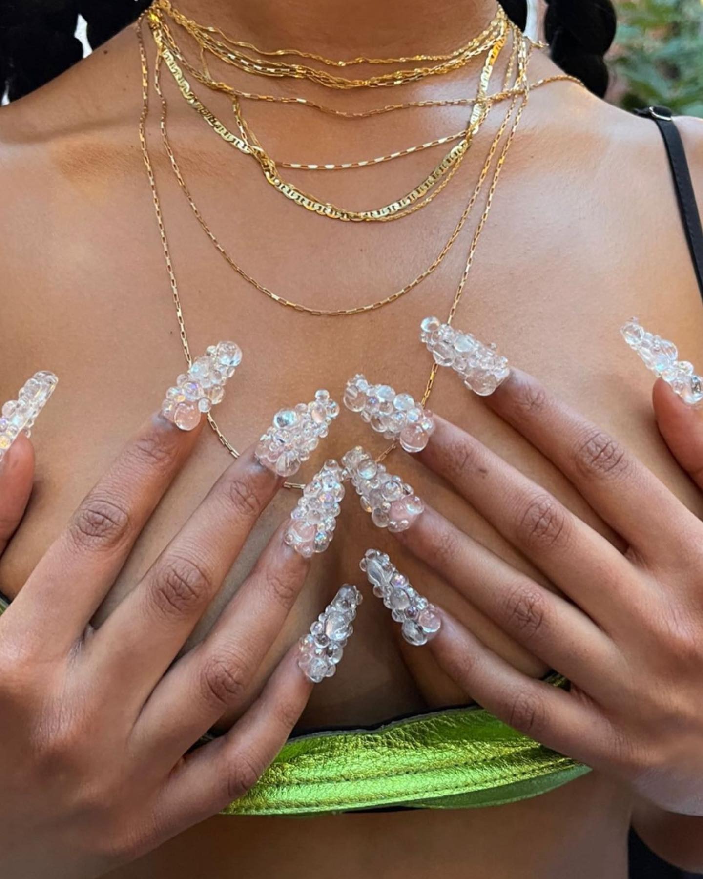 Woman wearing bubble acrylic nails.