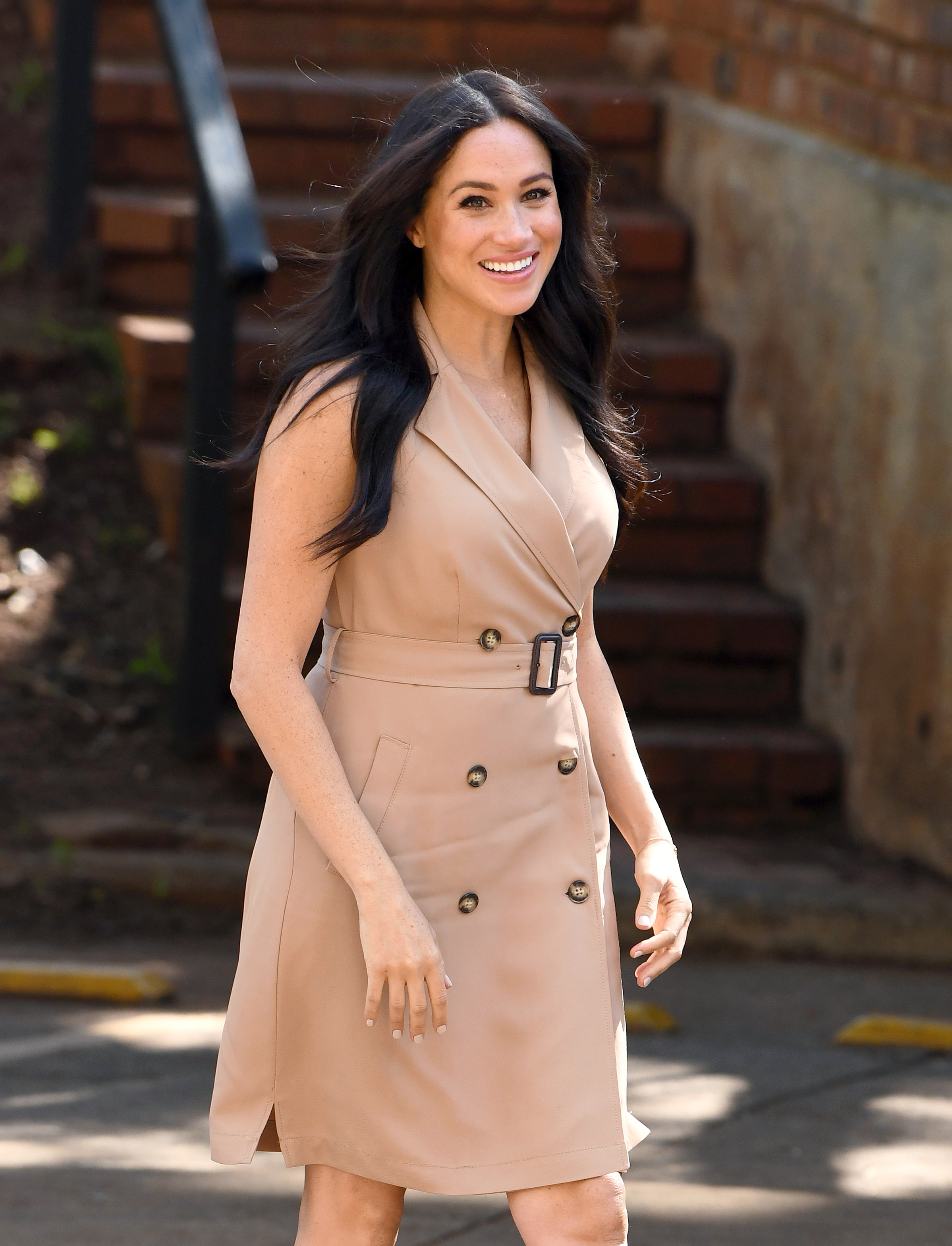 Meghan Markle wearing a sleeveless trench coat dress