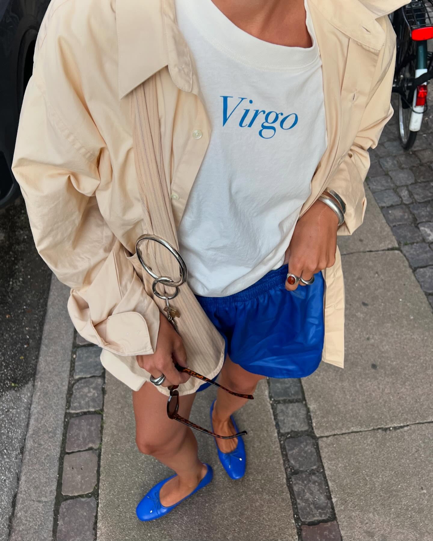 Influencer wears blue ballet flats.